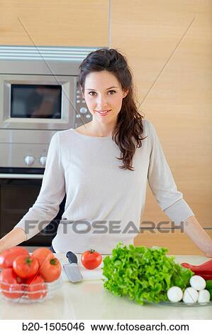 Young woman in kitchen View Large Photo Image Stock Photograph - Young woman in kitchen. Fotosearch