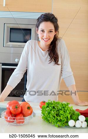 Young woman in kitchen View Large Photo Image Stock Photography - Young woman in kitchen. Fotosearch