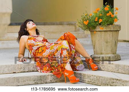 Young woman in lying next to a decorative vase View Large Photo Image Stock Photography - Young woman in lying next to a decorative vase. Fotosearch