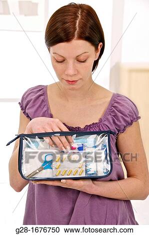 Young woman in mauve holding a transparent first aid kit. View Large Photo Image Stock Image - Young woman in mauve holding a transparent first aid kit.. Fotosearch