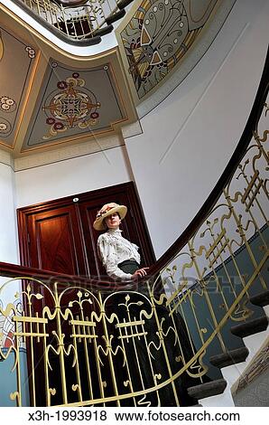 young woman in period costume in the spiral staircase of the Art Nouveau Museum which is located in the apartment where the Latvian architect Konstantins Peksens 1859? 1928 lived until 1907, Alberta street, Riga, Latvia, Baltic region, Northern Europe. View Large Photo Image Stock Photo - young woman in period costume in the spiral staircase of the Art Nouveau Museum which is located in the apartment where the Latvian architect Konstantins Peksens 1859? 1928 lived until 1907, Alberta street, Riga, Latvia, Baltic region, Northern Europe.. Fotosearch