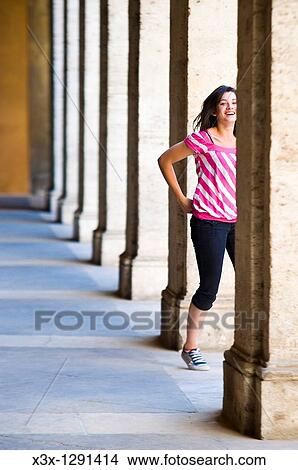Young woman in pink striped shirt walking among columns in Rome, Italy View Large Photo Image Picture - Young woman in pink striped shirt walking among columns in Rome, Italy. Fotosearch