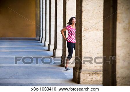Young woman in pink striped shirt walking among columns in Rome, Italy View Large Photo Image Stock Image - Young woman in pink striped shirt walking among columns in Rome, Italy. Fotosearch