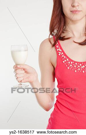 Young woman in red dress holding a wineglass with milk View Large Photo Image Stock Photo - Young woman in red dress holding a wineglass with milk. Fotosearch