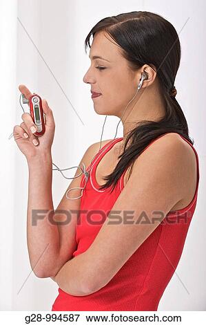 young woman in red top with her MP3 player View Large Photo Image Stock Photo - young woman in red top with her MP3 player. Fotosearch