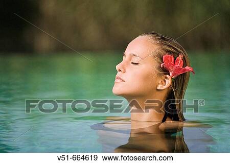 Young woman in swimming-pool with a flower. View Large Photo Image Stock Photo - Young woman in swimming-pool with a flower.. Fotosearch