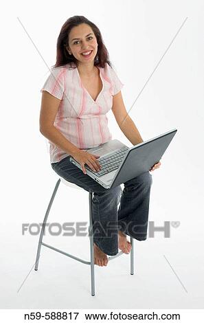 Young woman in the early stages of pregnancy shares her exciting news by email View Large Photo Image Stock Photo - Young woman in the early stages of pregnancy shares her exciting news by email. Fotosearch