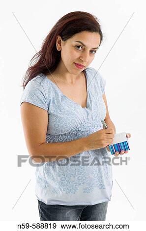 Young woman in the early stages of pregnancy thinking about possible names for her baby. View Large Photo Image Stock Photo - Young woman in the early stages of pregnancy thinking about possible names for her baby.. Fotosearch