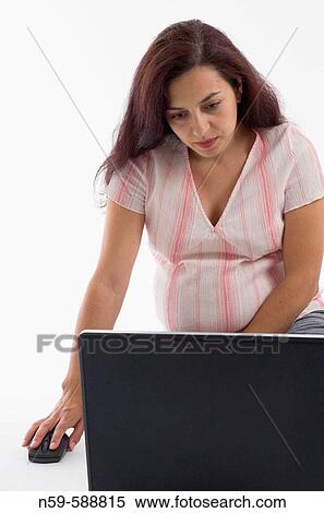 Young woman in the early stages of pregnancy using a laptop computer. View Large Photo Image Stock Photography - Young woman in the early stages of pregnancy using a laptop computer.. Fotosearch