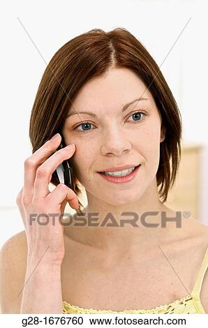 Young woman in yellow, using a portable phone View Large Photo Image Stock Image - Young woman in yellow, using a portable phone. Fotosearch