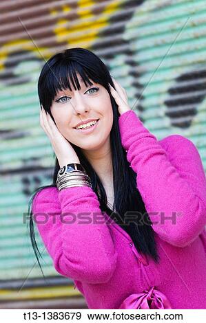 Young woman is hearing something View Large Photo Image Stock Photo - Young woman is hearing something. Fotosearch