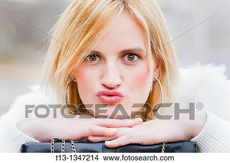 Picture - Young woman is kissing. Fotosearch
