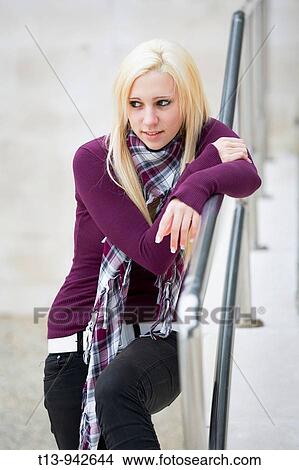 Young woman is lounging on metal fence View Large Photo Image Picture - Young woman is lounging on metal fence. Fotosearch