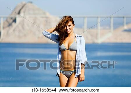 Young woman is posing in bikini and a shirt View Large Photo Image Picture - Young woman is posing in bikini and a shirt. Fotosearch