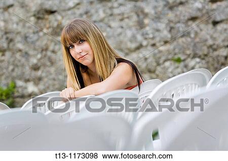 Young woman is sitting in an empty open air theater View Large Photo Image Stock Photo - Young woman is sitting in an empty open air theater. Fotosearch