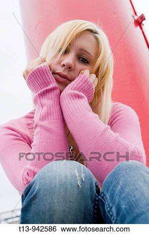 Young woman is sitting sad View Large Photo Image Stock Photograph - Young woman is sitting sad. Fotosearch
