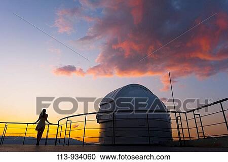 Young woman is standing next to space observatory telescope dome in sunset View Large Photo Image Stock Image - Young woman is standing next to space observatory telescope dome in sunset. Fotosearch