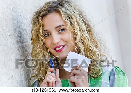 Young woman is taking notes View Large Photo Image Stock Photography - Young woman is taking notes. Fotosearch