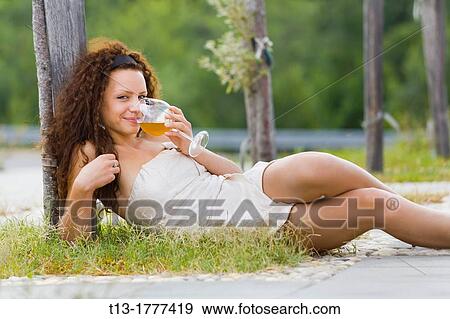 Young woman is teasing with a glass of wine in hand View Large Photo Image Stock Photo - Young woman is teasing with a glass of wine in hand. Fotosearch