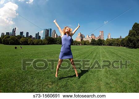 Young woman jumping in Central Park, New York, USA View Large Photo Image Stock Image - Young woman jumping in Central Park, New York, USA. Fotosearch
