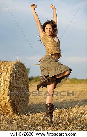 Stock Photograph - Young woman jumping in the countryside. Fotosearch