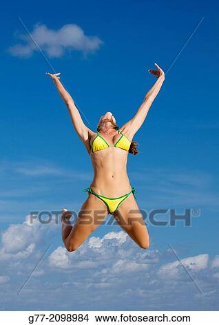 Young woman jumping on the beach, Miami Beach, Florida, USA View Large Photo Image Picture - Young woman jumping on the beach, Miami Beach, Florida, USA. Fotosearch