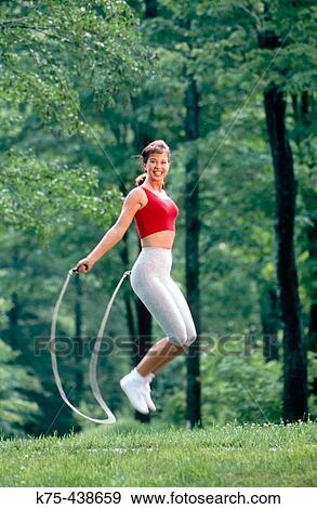 Stock Photo - Young woman jumping rope. Fotosearch