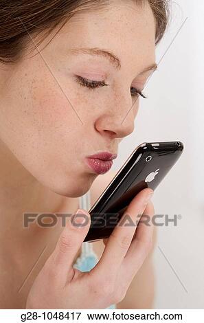 young woman kissing her telephone View Large Photo Image Stock Photo - young woman kissing her telephone. Fotosearch
