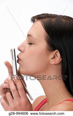 young woman kissing her telephone View Large Photo Image Stock Photograph - young woman kissing her telephone. Fotosearch