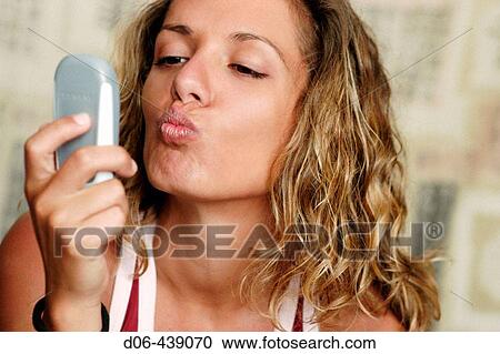 young woman kissing mobile phone View Large Photo Image Stock Image - young woman kissing mobile phone. Fotosearch