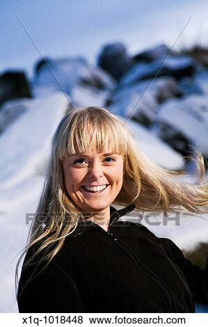 Stock Photo - Young woman laughing. Wintertime, Iceland. Fotosearch