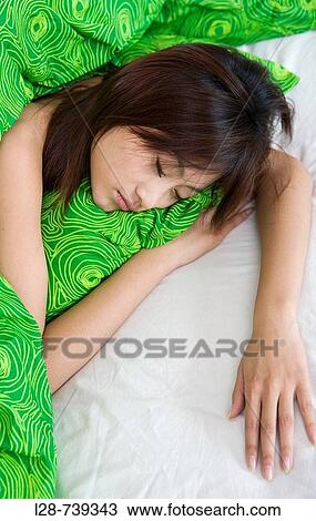 young woman laying in bed sleeping View Large Photo Image Stock Image - young woman laying in bed sleeping. Fotosearch
