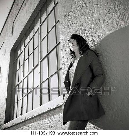 Young woman, leaning on building View Large Photo Image Stock Image - Young woman, leaning on building. Fotosearch