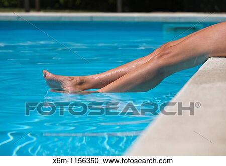 young woman legs in a swimming pool View Large Photo Image Stock Image - young woman legs in a swimming pool. Fotosearch