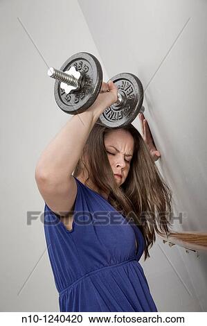 Young woman lifting weights View Large Photo Image Stock Image - Young woman lifting weights. Fotosearch