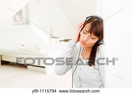 Young woman listening music. View Large Photo Image Picture - Young woman listening music.. Fotosearch