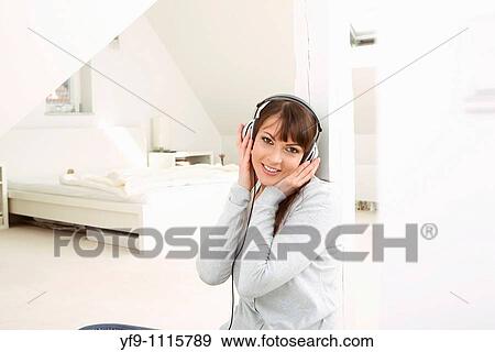 Young woman listening music. View Large Photo Image Stock Photo - Young woman listening music.. Fotosearch