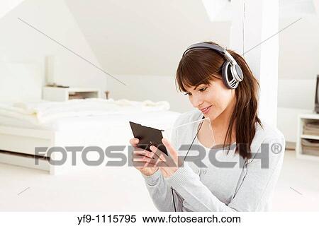 Young woman listening music. View Large Photo Image Stock Photography - Young woman listening music.. Fotosearch