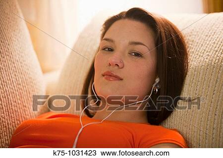 young woman listening to mp3 player View Large Photo Image Stock Image - young woman listening to mp3 player. Fotosearch