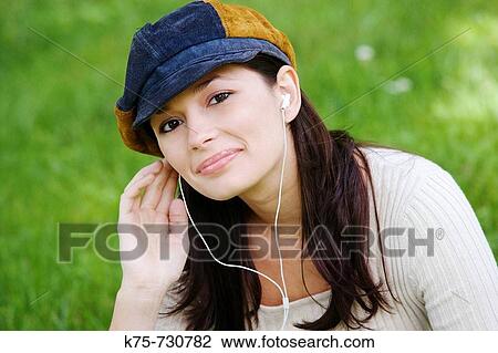 young woman listening to mp3 player View Large Photo Image Stock Image - young woman listening to mp3 player. Fotosearch