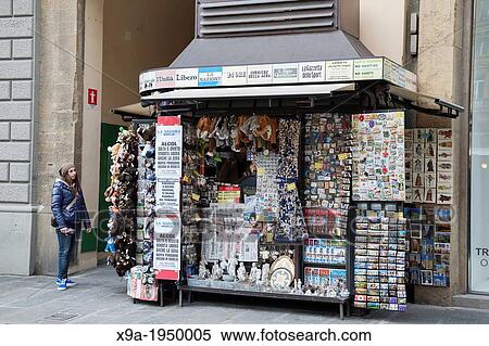 Stock Photography - Young Woman looking at Souvenir Stalland News Stand in Florence, Italy.. Fotosearch