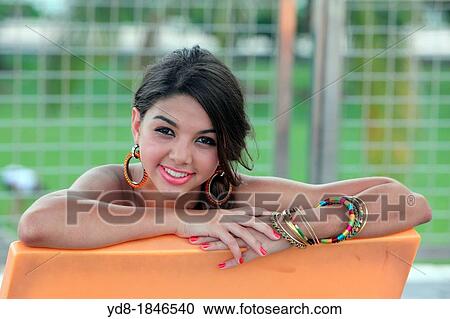 Young woman looking at the camera smailing, Miami Beach, Florida, USA View Large Photo Image Stock Image - Young woman looking at the camera smailing, Miami Beach, Florida, USA. Fotosearch
