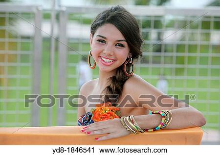 Young woman looking at the camera smailing, Miami Beach, Florida, USA View Large Photo Image Stock Image - Young woman looking at the camera smailing, Miami Beach, Florida, USA. Fotosearch