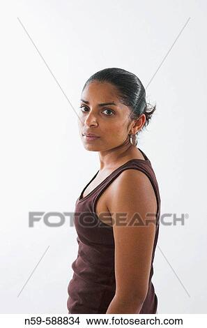 Picture - Young woman looking back over her shoulder.. Fotosearch