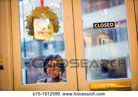 young woman looking inside through a closed door in Soho, London, England, UK View Large Photo Image Stock Photo - young woman looking inside through a closed door in Soho, London, England, UK. Fotosearch