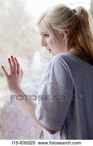 Young woman looking out of window, sad, depressed, anticipating something, boredom View Large Photo Image Stock Image - Young woman looking out of window, sad, depressed, anticipating something, boredom. Fotosearch