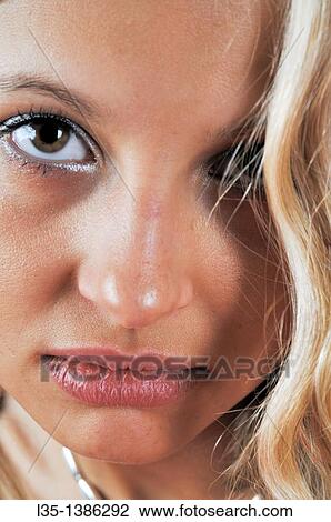 Stock Image - Young woman looking sad. Fotosearch