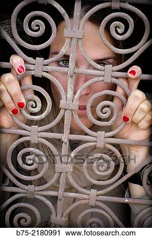 Young woman looking through a fence of a window in the Medina of Fez, Morocco, Africa. View Large Photo Image Stock Image - Young woman looking through a fence of a window in the Medina of Fez, Morocco, Africa.. Fotosearch