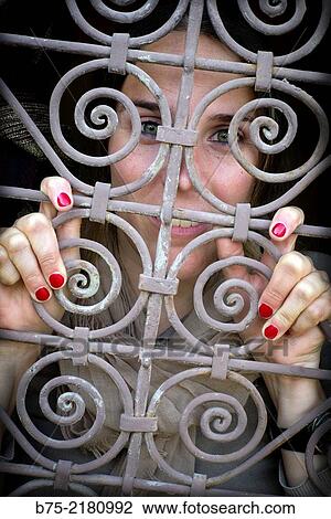 Young woman looking through a fence of a window in the Medina of Fez, Morocco, Africa. View Large Photo Image Stock Image - Young woman looking through a fence of a window in the Medina of Fez, Morocco, Africa.. Fotosearch