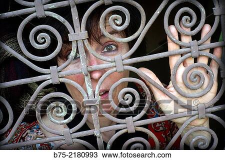Young woman looking through a fence of a window in the Medina of Fez, Morocco, Africa. View Large Photo Image Stock Image - Young woman looking through a fence of a window in the Medina of Fez, Morocco, Africa.. Fotosearch